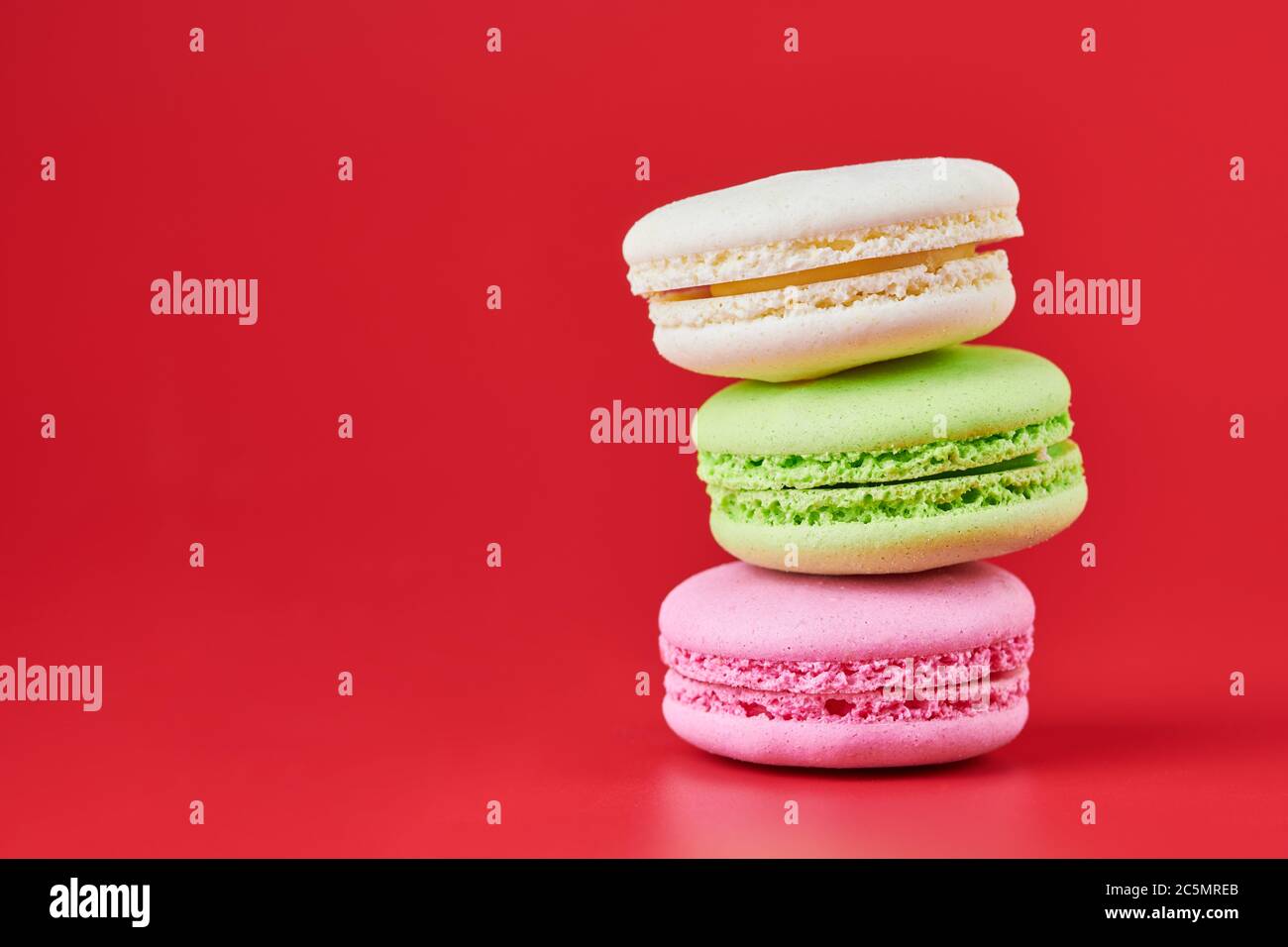 Macaroons on red background. Colorful small cookie from ground almonds ...