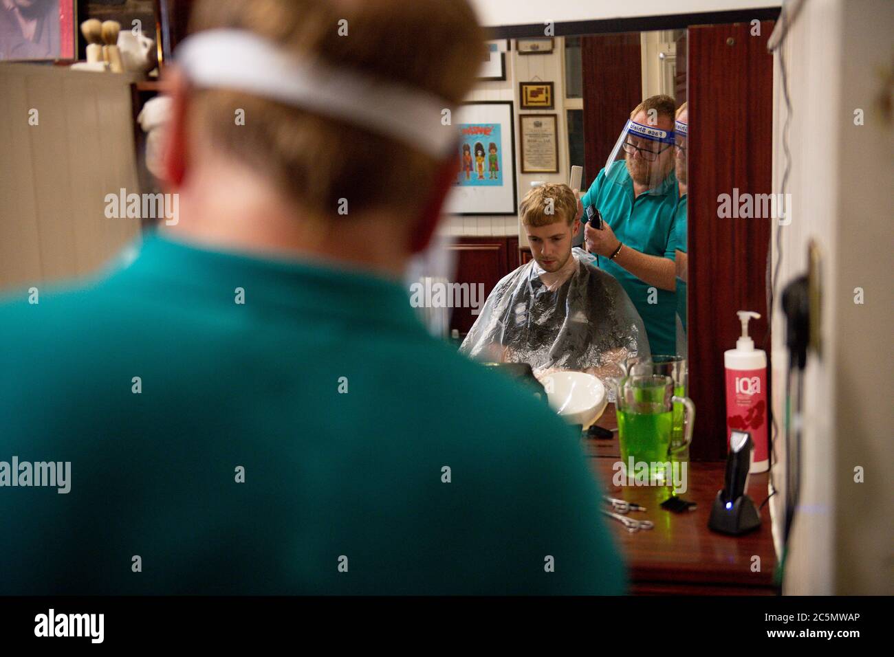 The first customers at the reopening of Jakes Barbers in Birmingham, as coronavirus lockdown restrictions are eased across England. Stock Photo