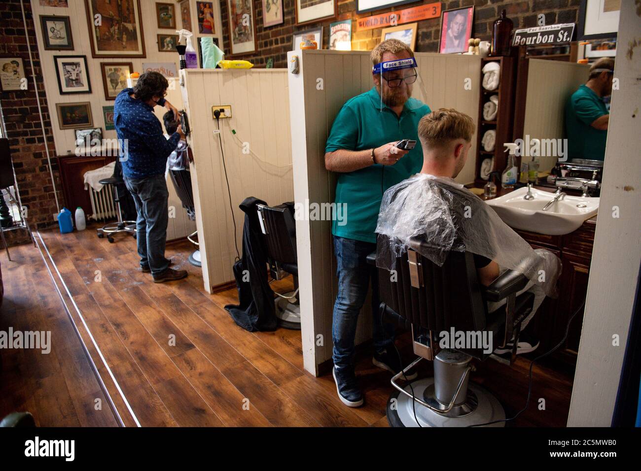 The first customers at the reopening of Jakes Barbers in Birmingham, as coronavirus lockdown restrictions are eased across England. Stock Photo