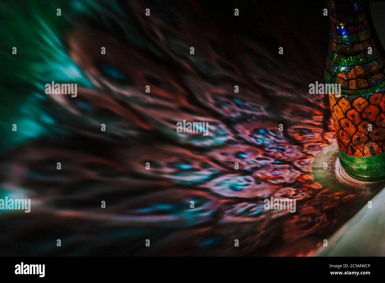 light passing through an bottle with colored art Stock Photo