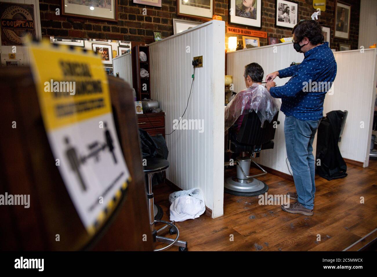 The first customers at the reopening of Jakes Barbers in Birmingham, as coronavirus lockdown restrictions are eased across England. Stock Photo
