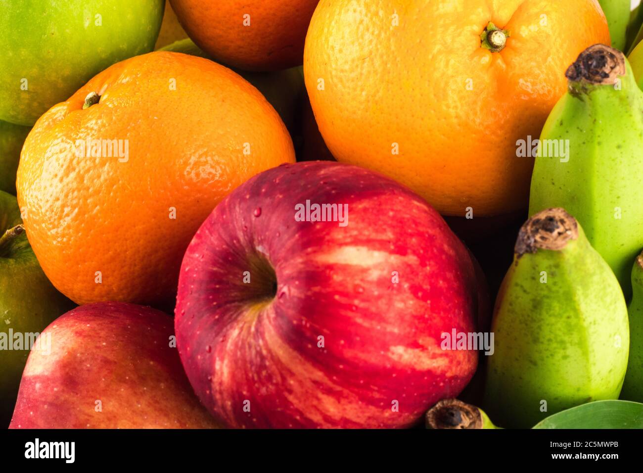 green apple and orange and red apple and banana are mixed tasty fruit composition on  background fruit health food Stock Photo