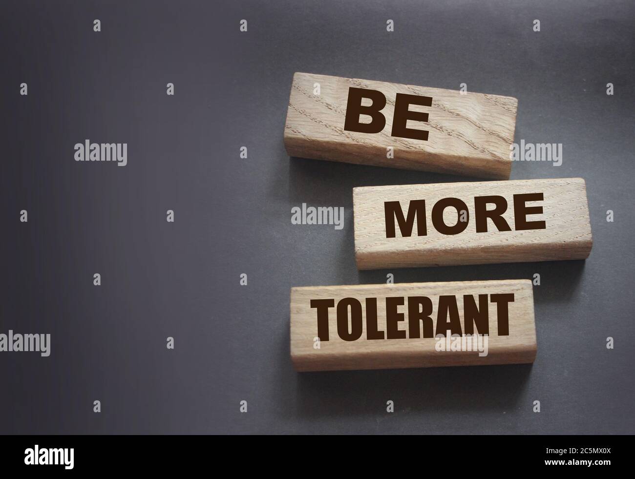 Be More Tolerant words on wooden blocks on dark background. Tolerance Equality diversity social concept Stock Photo