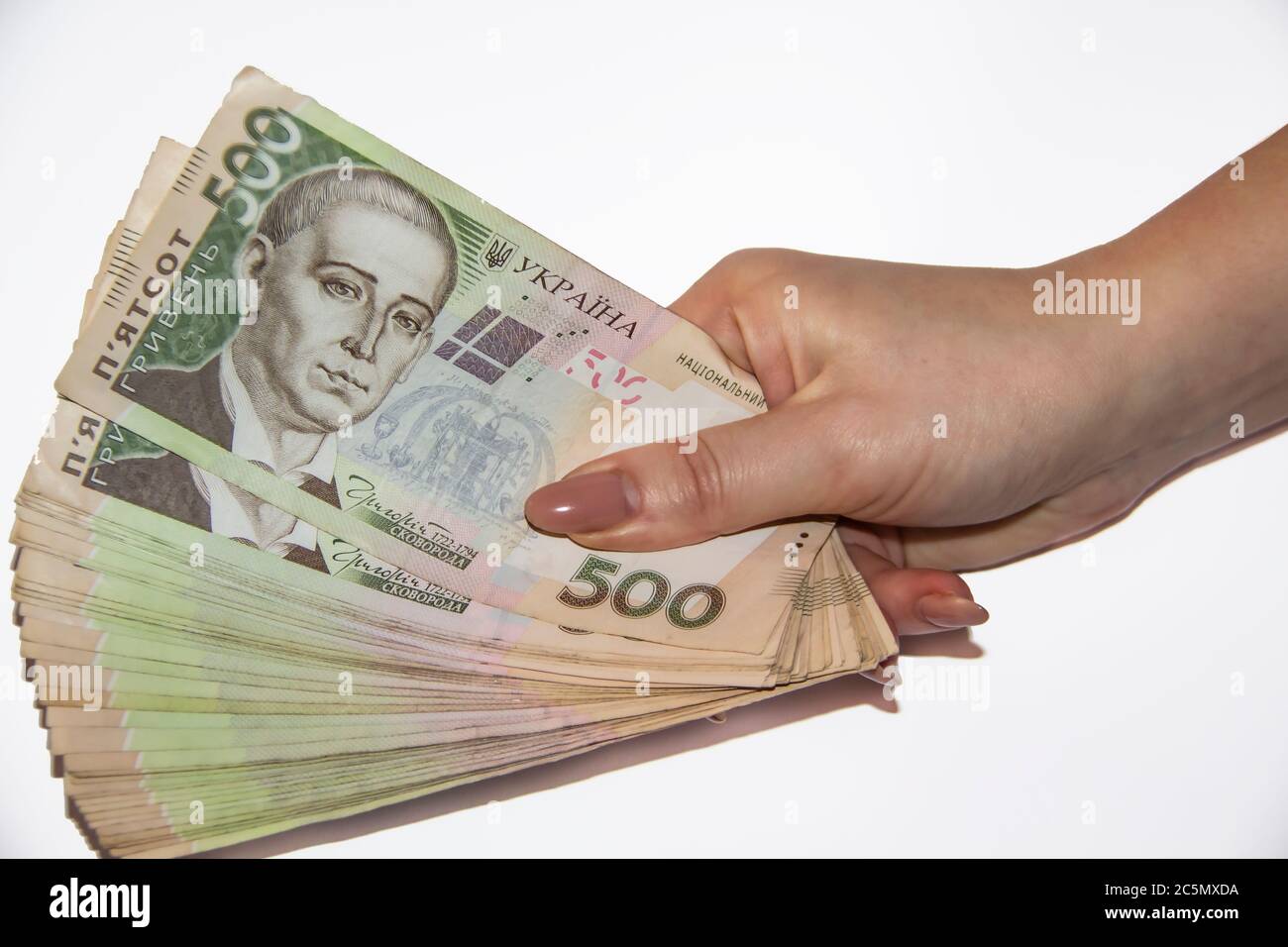 A female hand hold Ukrainian money. Hryvnia 500. Ukrainian bills of five hundred hryvnia. Several Ukrainian hryvnia banknotes. Stock Photo
