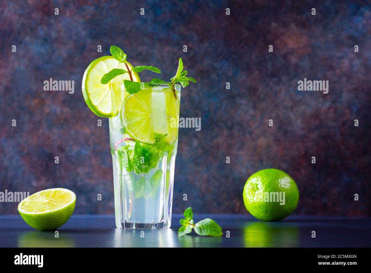 Mojito cocktail with lime and mint in tall glass. Fresh mojito in glass ...