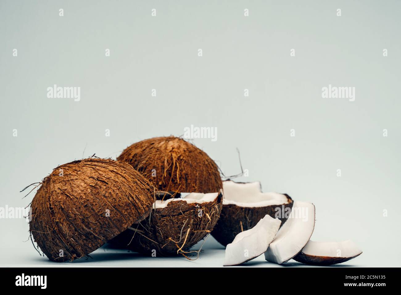 Parts of coconut on a colored background. Close up. Fresh ripe coconut ...