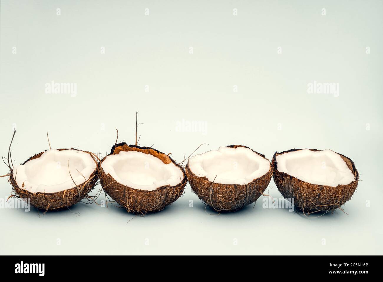 Parts of coconut on a colored background. Close up. Fresh ripe coconut