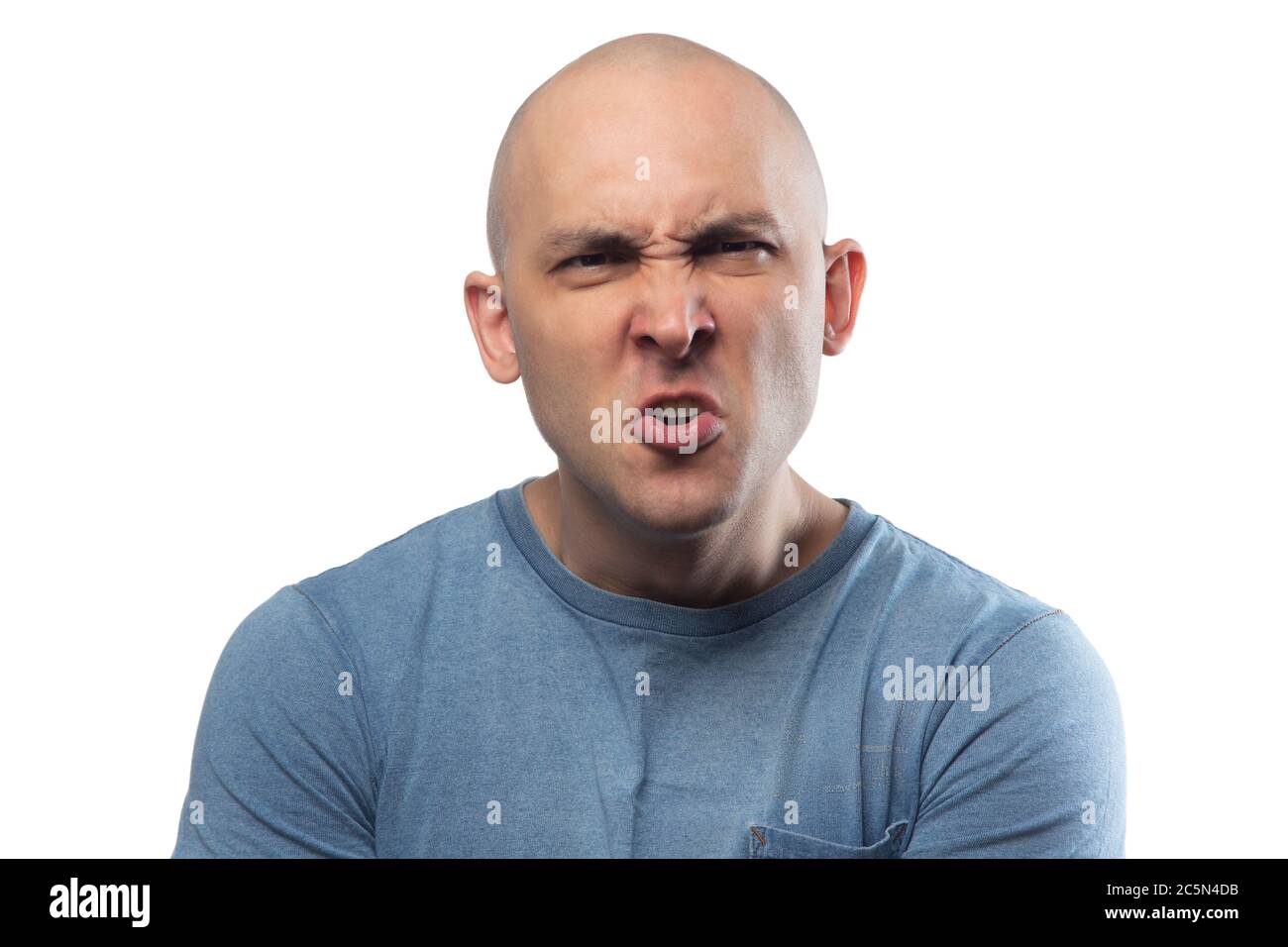 Photo of young bald aggressive man in blue tee shirt Stock Photo