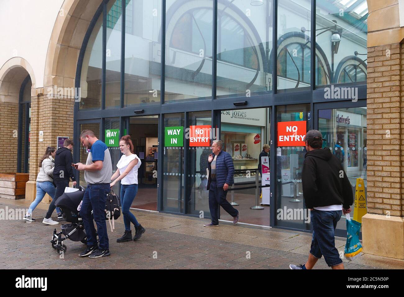 Hastings, East Sussex, UK. 04 Jul, 2020. Coronavirus update: With the government relaxing the rules further, bars, pubs, restaurants and barbershops are allowed to open. Clear signage indicating in and out at this shopping mall in Hastings. Photo Credit: Paul Lawrenson-PAL Media/Alamy Live News Stock Photo