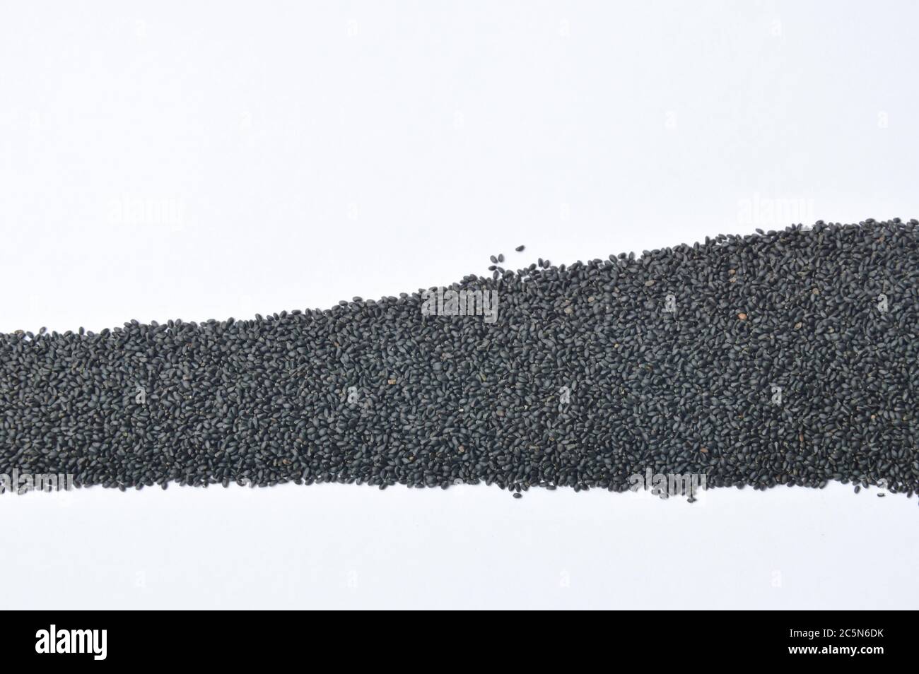 raw black sesame on white background Stock Photo - Alamy