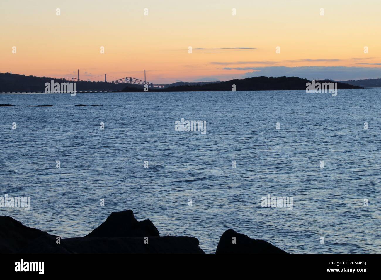 Cramond Island and Forth bridges at sunset Stock Photo