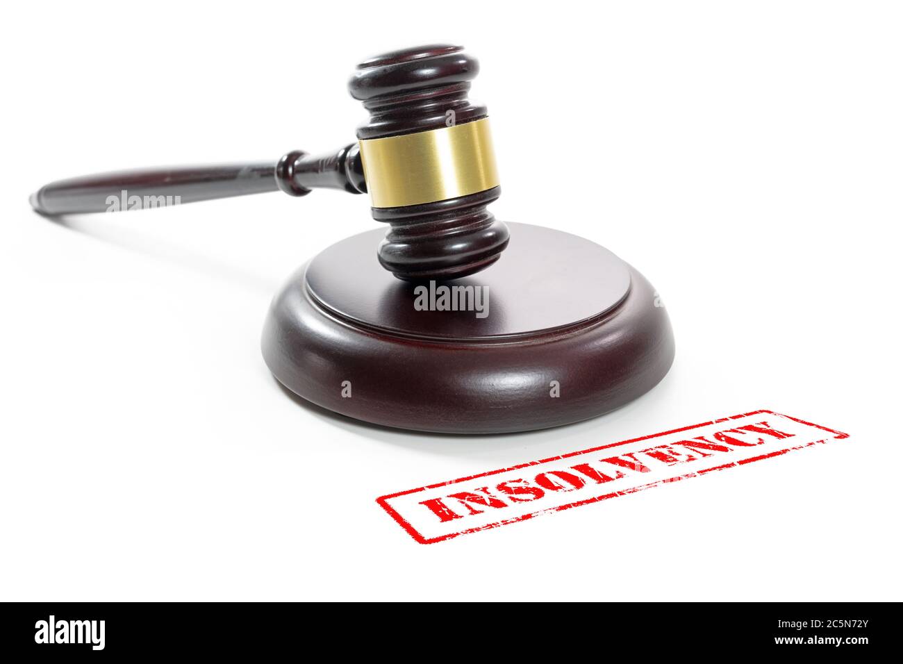 Judge gavel and a red stamp with the word Insolvency, companies are going bankrupt due to the coronavirus crisis, isolated on a white background Stock Photo