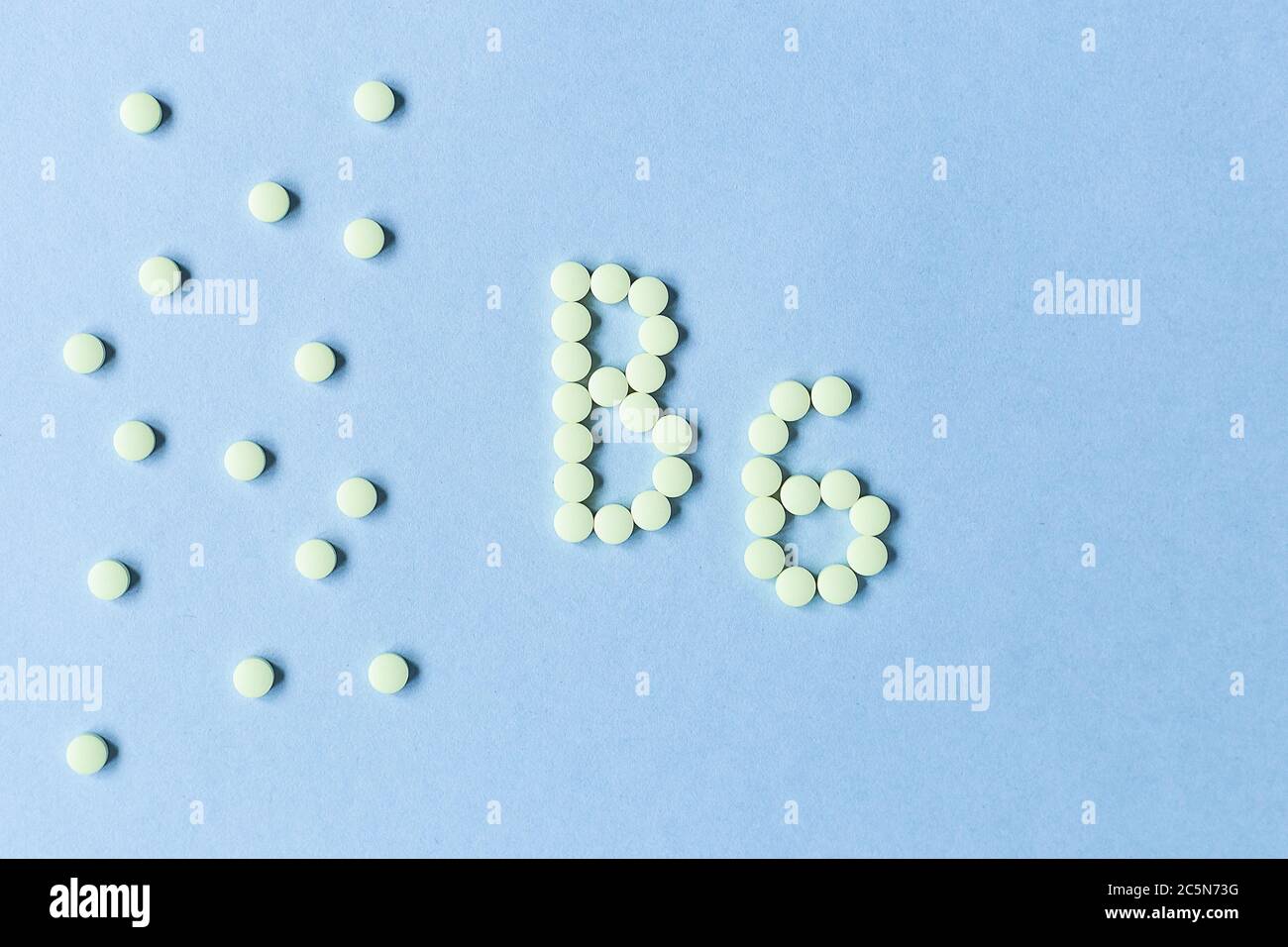 Vitamin B6 pills forming the word B6 over turquoise background, banner. free space. copy space. soft focus, blurry background. space for text. nutriti Stock Photo