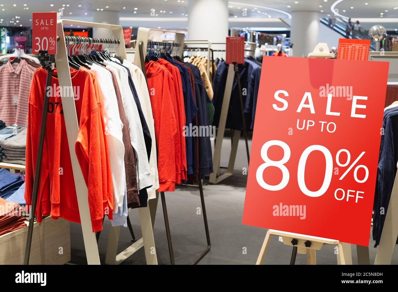 Sales Woman Offers Discount Clothes on Sale. Boutique Sale Stock