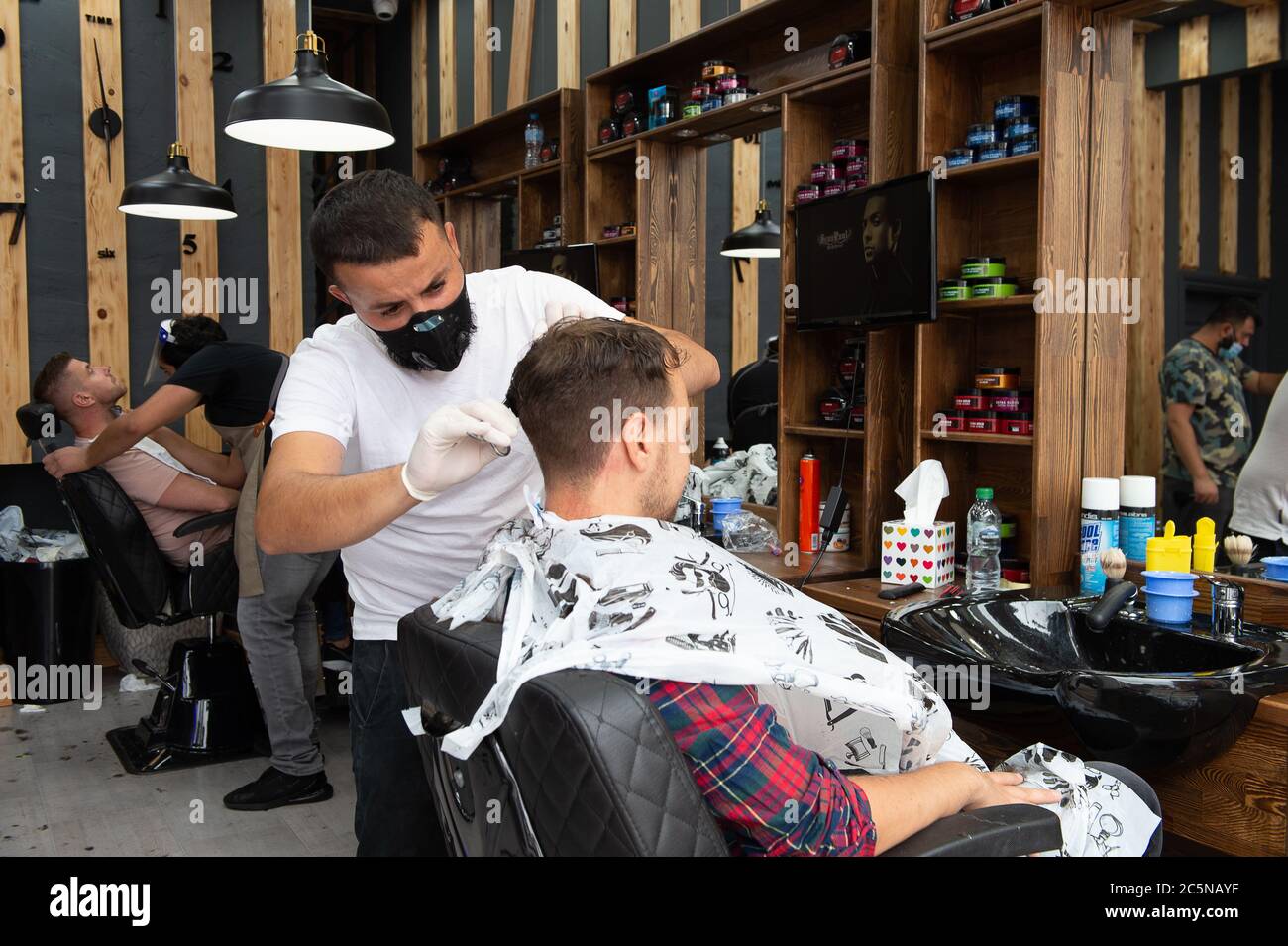 Eton, Windsor, Berkshire, UK. 4th July, 2020. A busy morning at Popeye's Grooming Authentic Turkish Barbers in Eton High Street, Windsor, Berkshire. Barbers were allowed to reopen in England from today for the first time since the Coronavirus Covid-19 lockdown in March. Credit: Maureen McLean/Alamy Live News Stock Photo