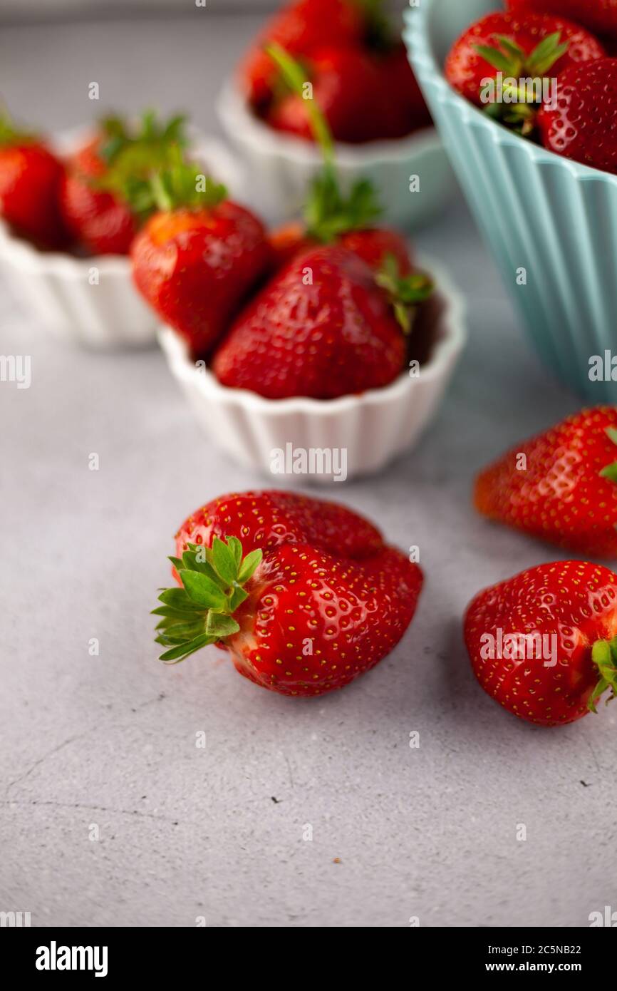 Strawberries on the table top view. Red berries pattern. Strawberry crop. Food still life in the spotlight. Red berry background. Stock Photo