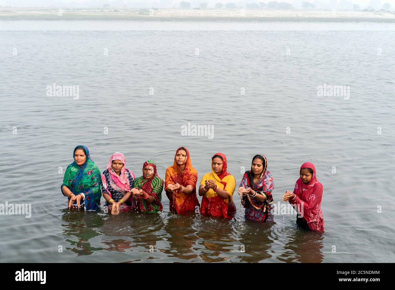 Hindu women offer prayers to Hindu God after ritual bath in holy Yamuna river in Vrindavan, Uttar Pradesh, India. Stock Photo