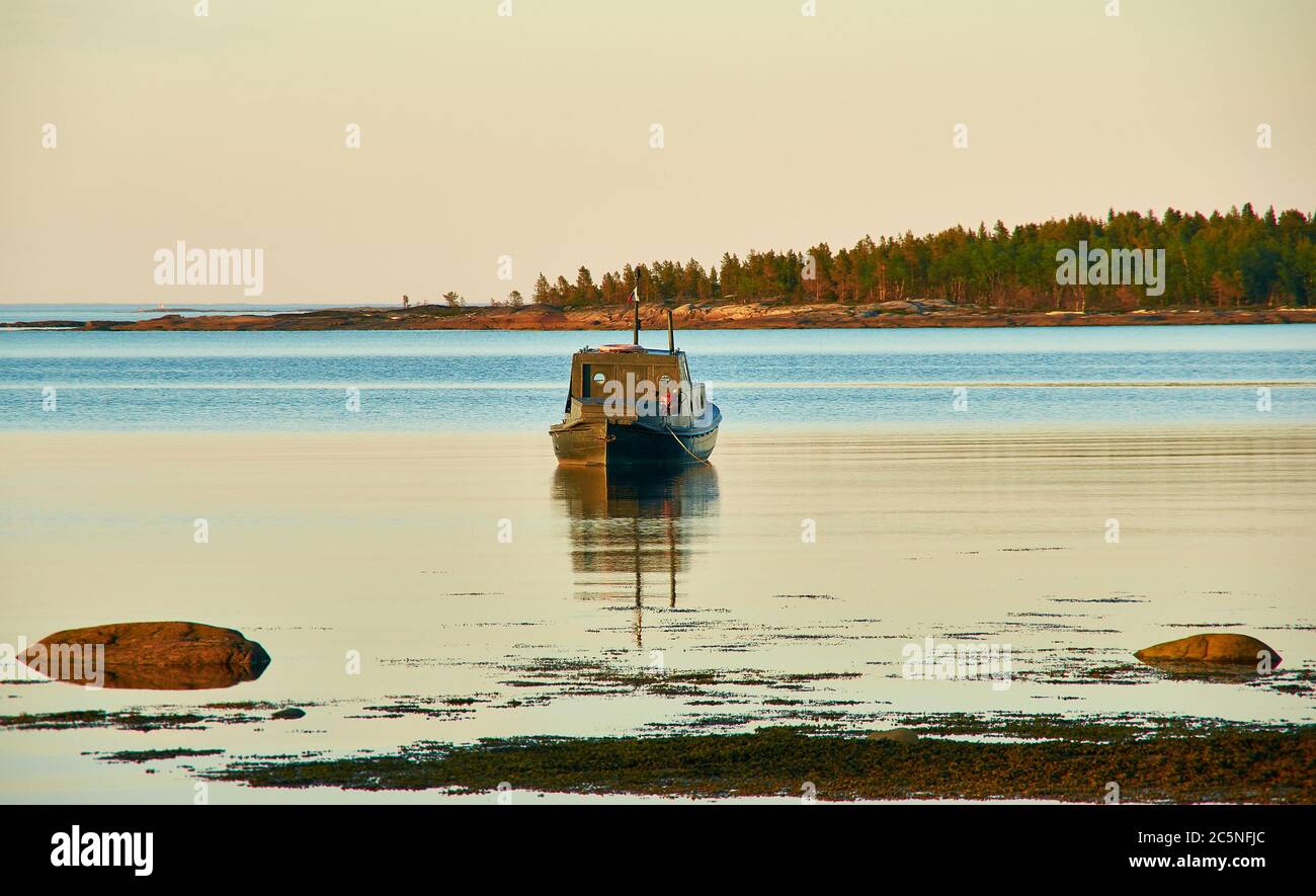 Boat in the village of Rabocheostrovsk, Russia. White Sea near Kem Stock Photo