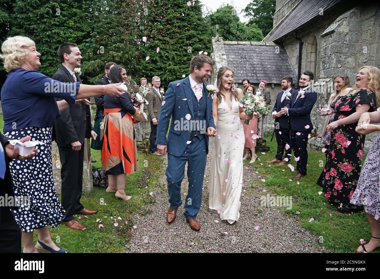 The newly married Mr and Mrs Bone, Lucy and James, after their wedding at St Michael and all Angels Church in Ingram, Northumberland, as weddings are once again permitted to take place in England, with ceremonies capped at a maximum of 30 guests. Stock Photo
