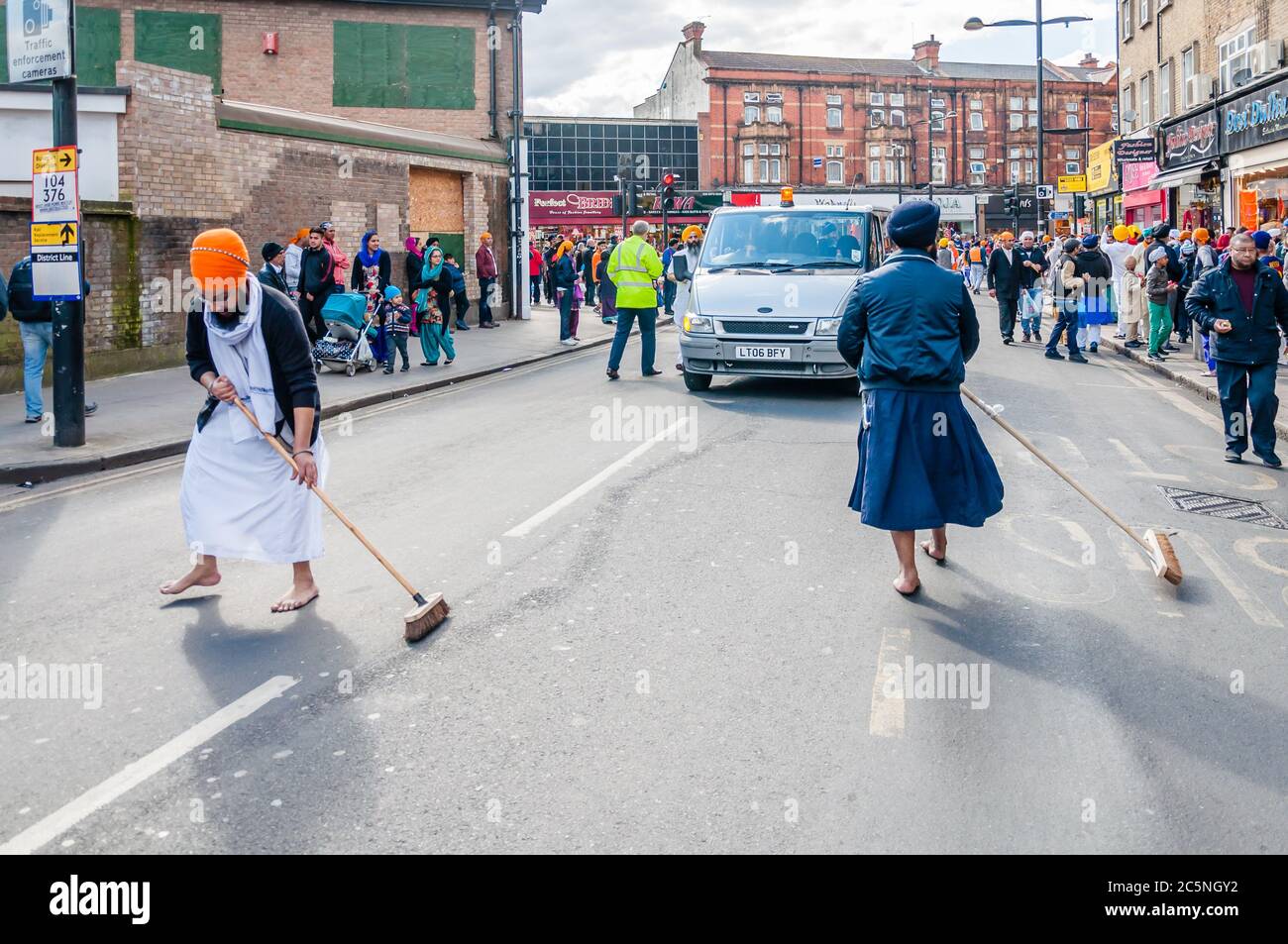 Devotees remove their shoes to sweep the road clean take part in the festival of Vaisakhi, celebrating the birth of Sikhs Stock Photo