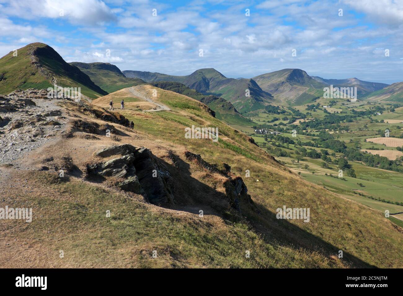 Looking towards the head of the Newlands Valley from the eroded ridge path leading up to the popular Lake District summit of Cat Bells Stock Photo