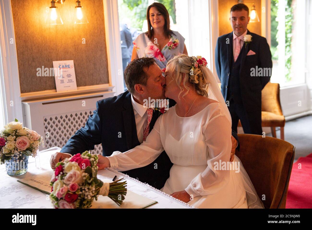 Tracie Kenny and Neal Arden at their wedding ceremony at The Best Western Valley Hotel, Ironbridge, as weddings are once again permitted to take place in England, with ceremonies capped at a maximum of 30 guests. Stock Photo