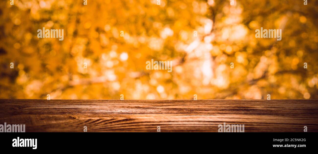 Empty wooden deck table with foliage bokeh background. Ready for ...