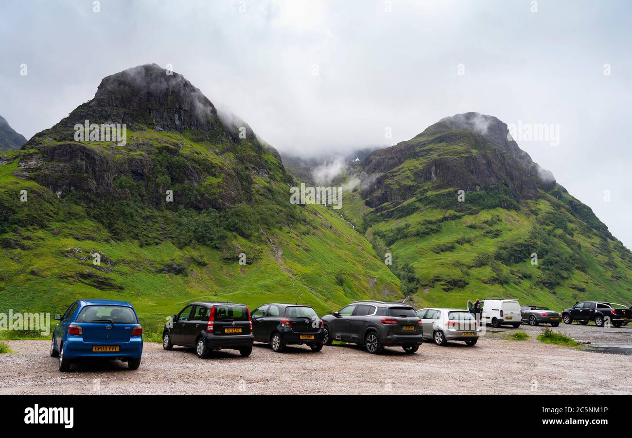 Glen Coe, Scotland, UK. 4 July, 2020. Tourists travel to Glen Coe on first weekend after 5 mile travel restriction was lifted by the Scottish Government. Pictured; Many tourist cars parked at Glen Coe viewpoint . Iain Masterton/Alamy Live News Stock Photo
