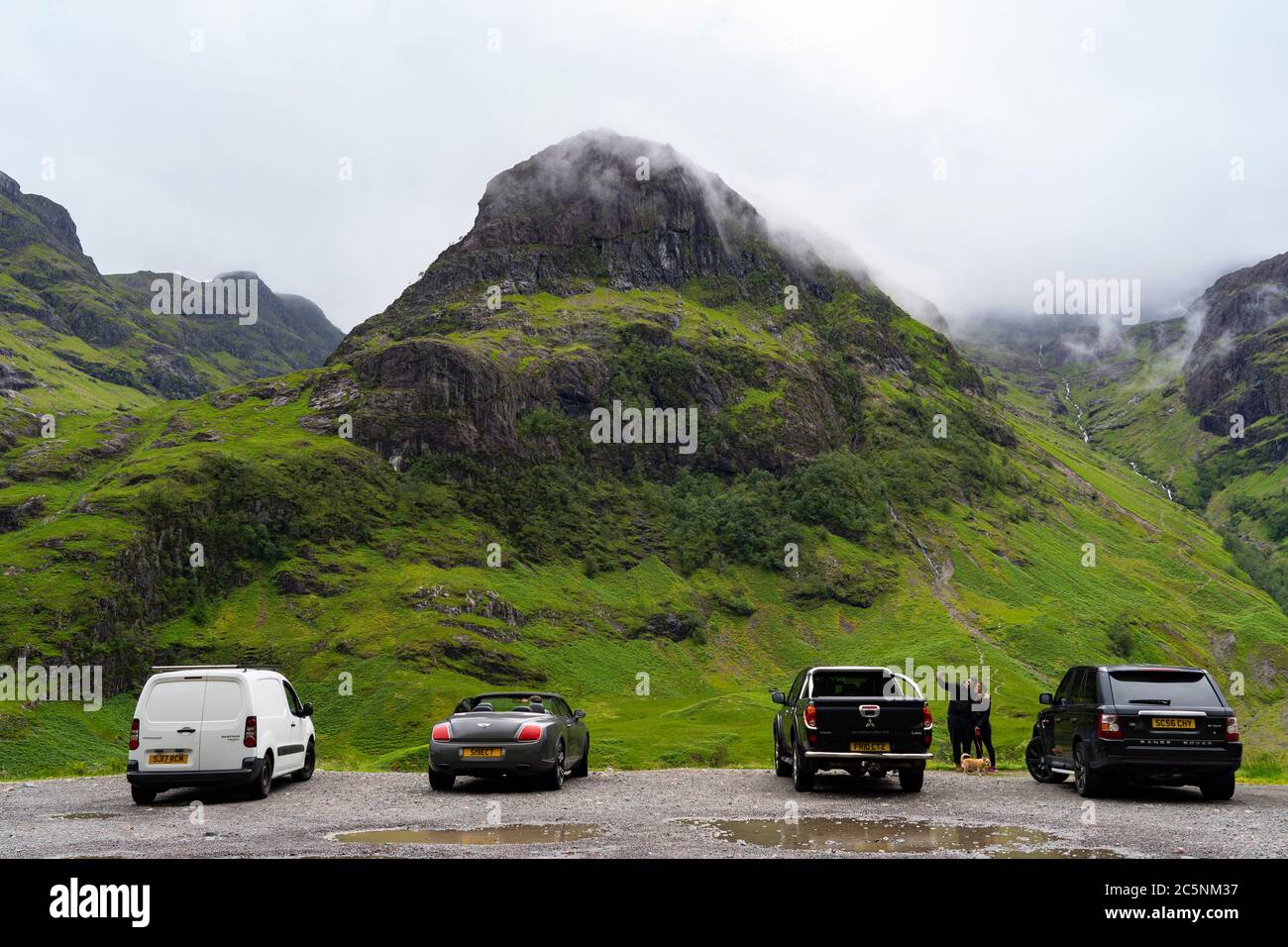 Glen Coe, Scotland, UK. 4 July, 2020. Tourists travel to Glen Coe on first weekend after 5 mile travel restriction was lifted by the Scottish Government. Pictured; Many tourist cars parked at Glen Coe viewpoint . Iain Masterton/Alamy Live News Stock Photo
