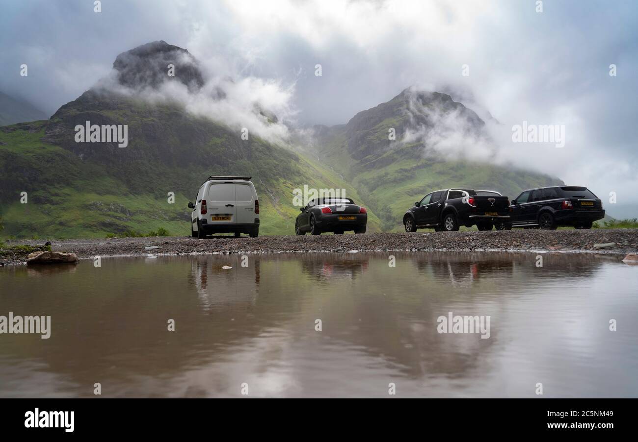 Glen Coe, Scotland, UK. 4 July, 2020. Tourists travel to Glen Coe on first weekend after 5 mile travel restriction was lifted by the Scottish Government. Pictured; Many touristsÕ cars parked at Glen Coe viewpoint . Iain Masterton/Alamy Live News Stock Photo
