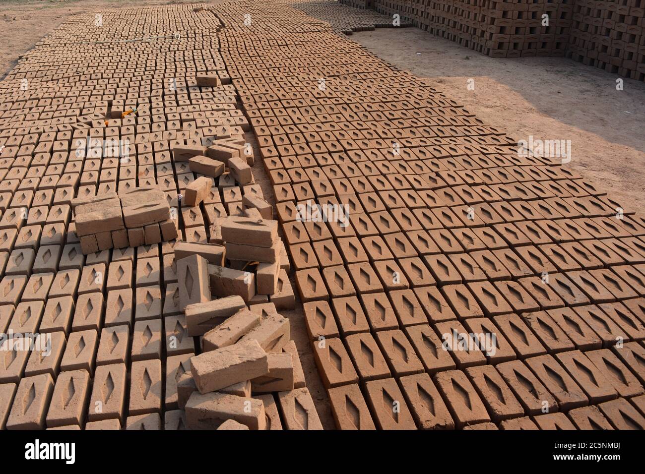 Raw brick laid out in stacks for drying. Bricks in a brick factory