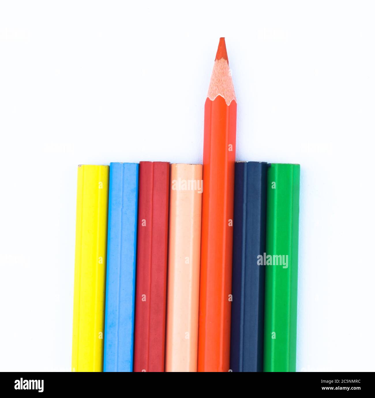 Seven different colored wood pencil crayon while the middle one facing