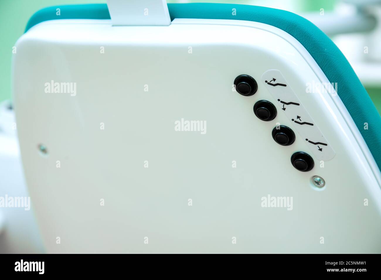 Buttons control the height and tilt of the dental chair for the patient