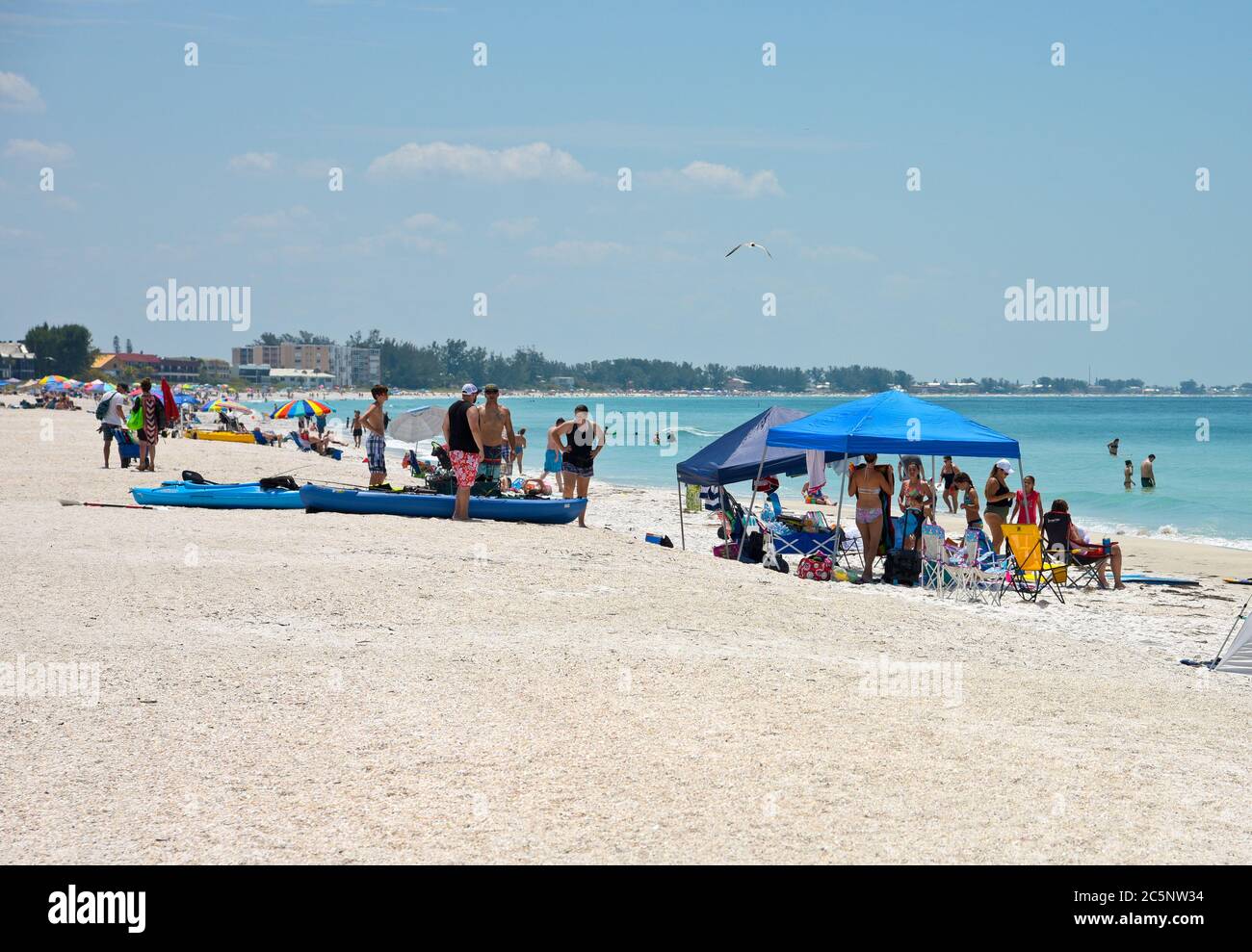 Holmes Beach, FL / USA -April 29, 2018:  Crowds of People on the Beach Enjoying the Beautiful Florida Beach Stock Photo