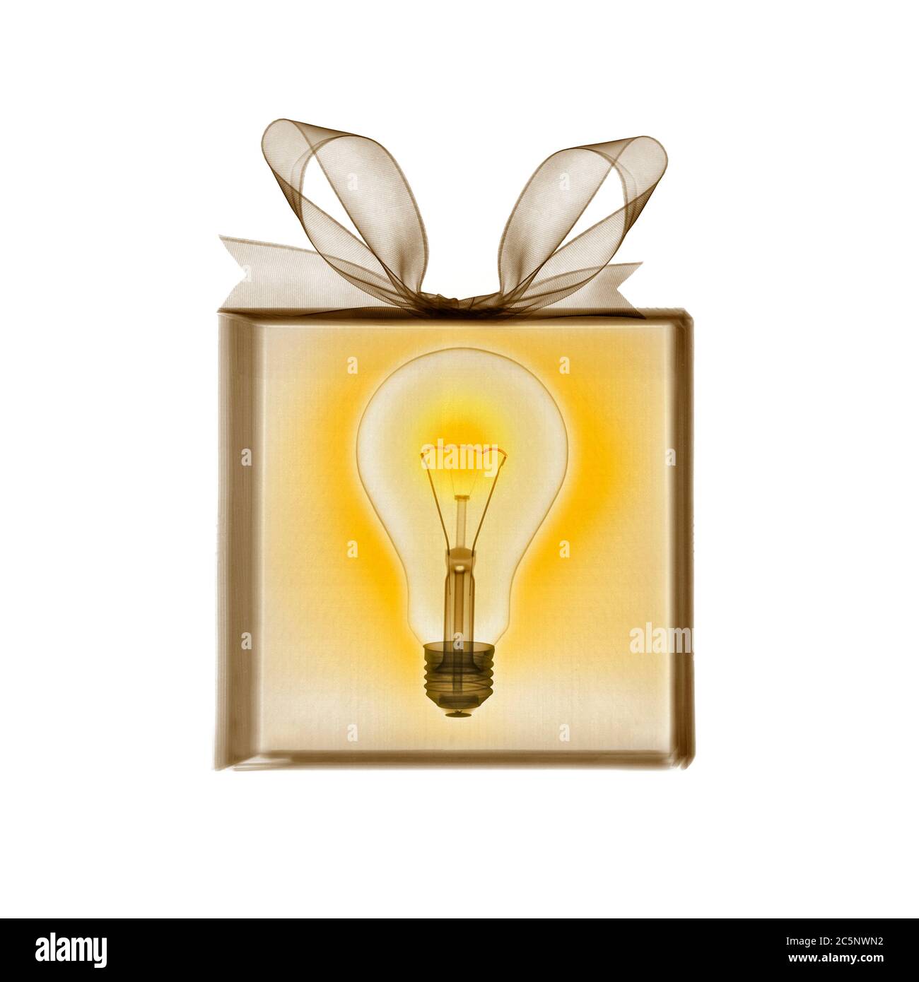 Gift wrapped present containing glowing light bulb, coloured X-ray. Stock Photo