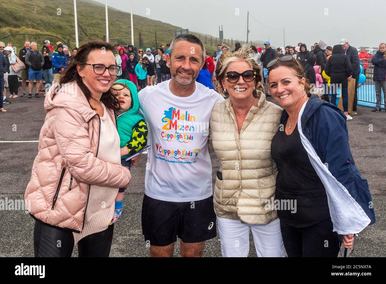 West Cork, Ireland. 4th July, 2020. Barry Sheehan, who lives in Cork, has ran 600 kms from Malin to Mizen Head in aid of the new children's unit 'Cappagh Kids' of National Orthopaedic Hospital, Cappagh, Dublin. Barry is pictured with his mum and two sisters after crossing the finish line. Credit: AG News/Alamy Live News Stock Photo