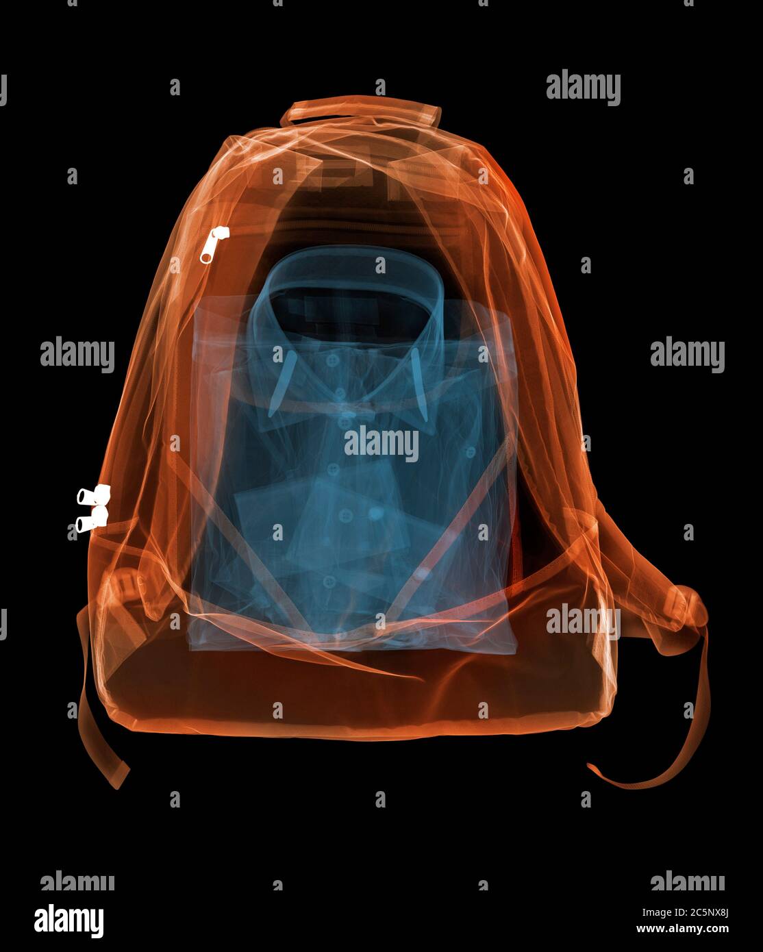 Shirt in backpack, coloured X-ray. Stock Photo