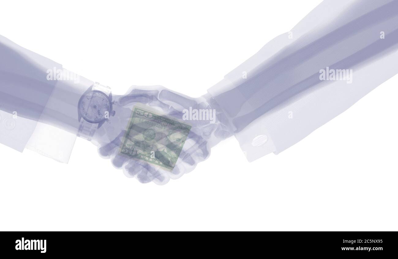 Businessmen shaking hands, coloured X-ray. Stock Photo