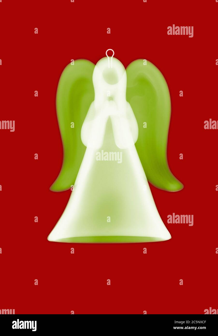 Angel ornament, coloured X-ray. Stock Photo