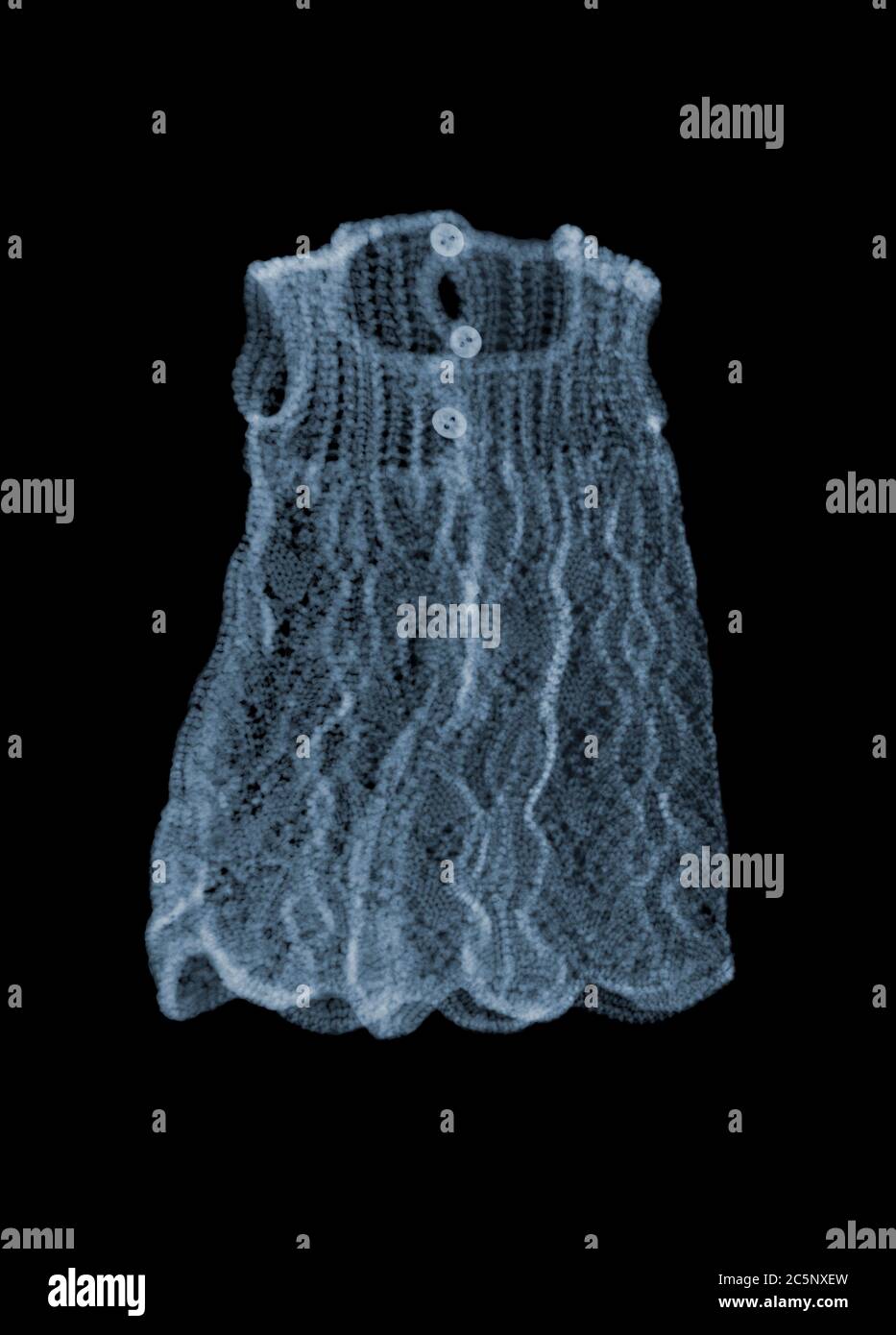 Doll knitted dress, coloured X-ray. Stock Photo