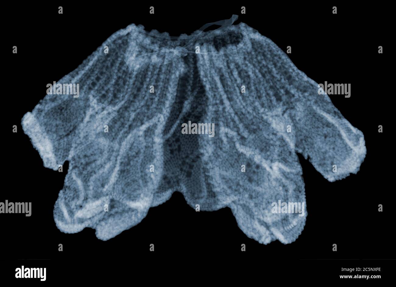 Doll knitted shawl, coloured X-ray. Stock Photo