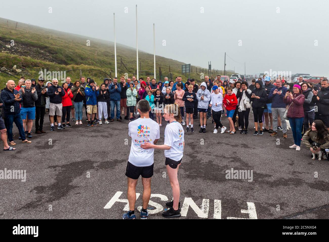West Cork, Ireland. 4th July, 2020. Barry Sheehan, who lives in Cork, has ran 600 kms from Malin to Mizen Head in aid of the new children's unit 'Cappagh Kids' of National Orthopaedic Hospital, Cappagh, Dublin. Barry is pictured adressing his many supporters after crossing the finish line. Credit: AG News/Alamy Live News Stock Photo