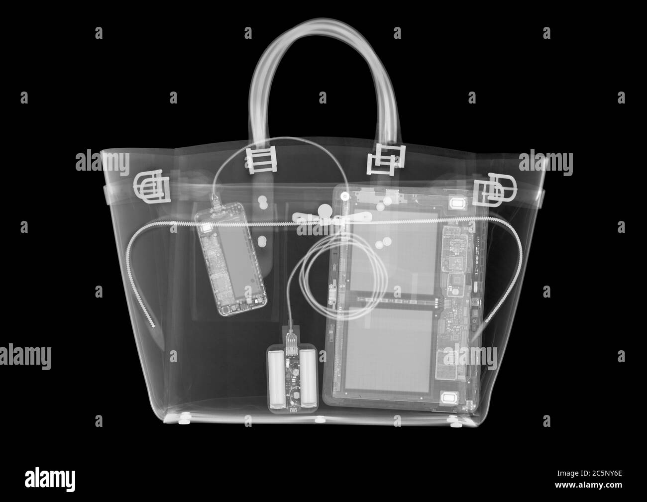 Fashion handbag containing computer devices, X-ray. Stock Photo