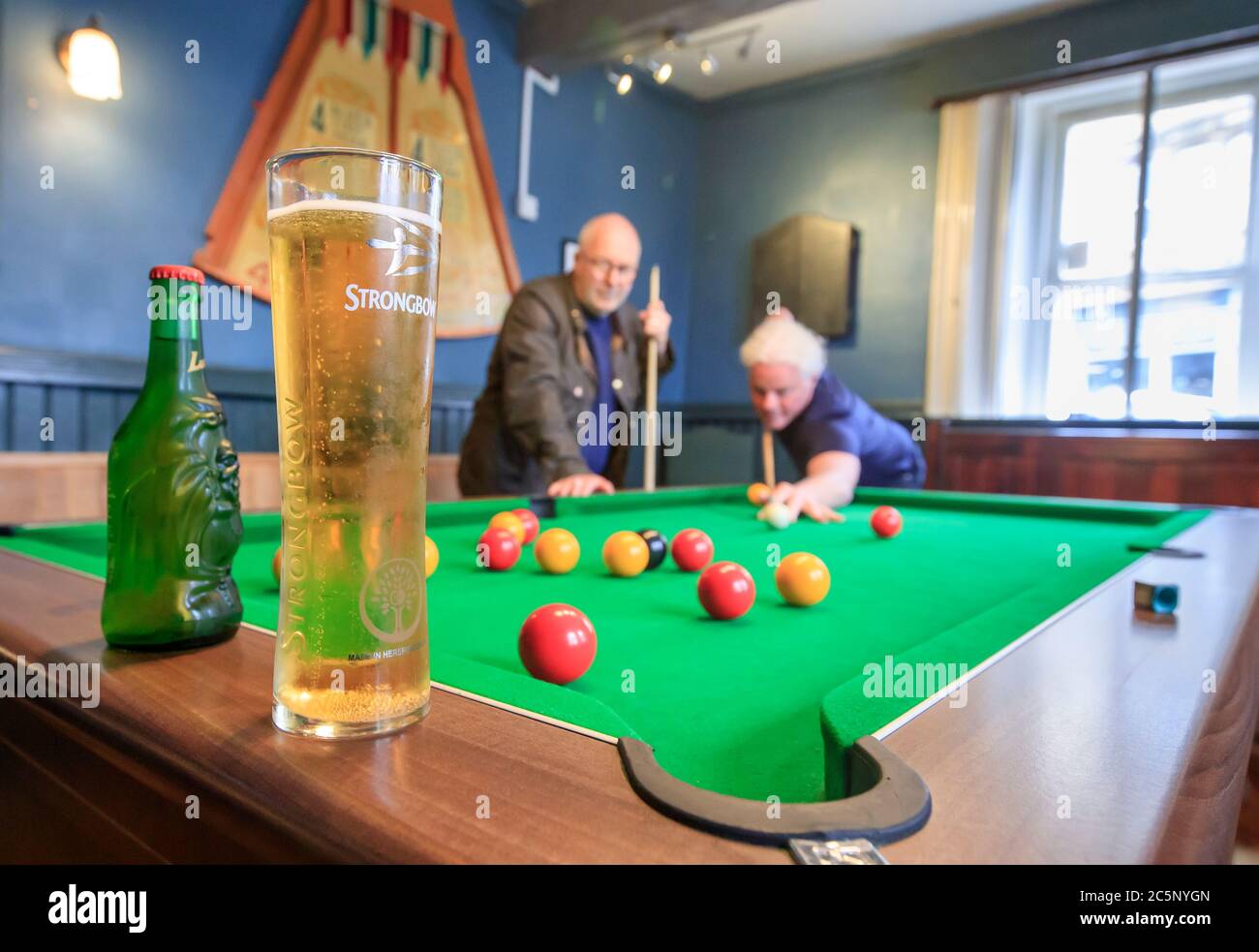 A customers play pool at the Golden Lion pub in Todmorden, West Yorkshire, as it reopens following the easing of coronavirus lockdown restrictions across England. Stock Photo