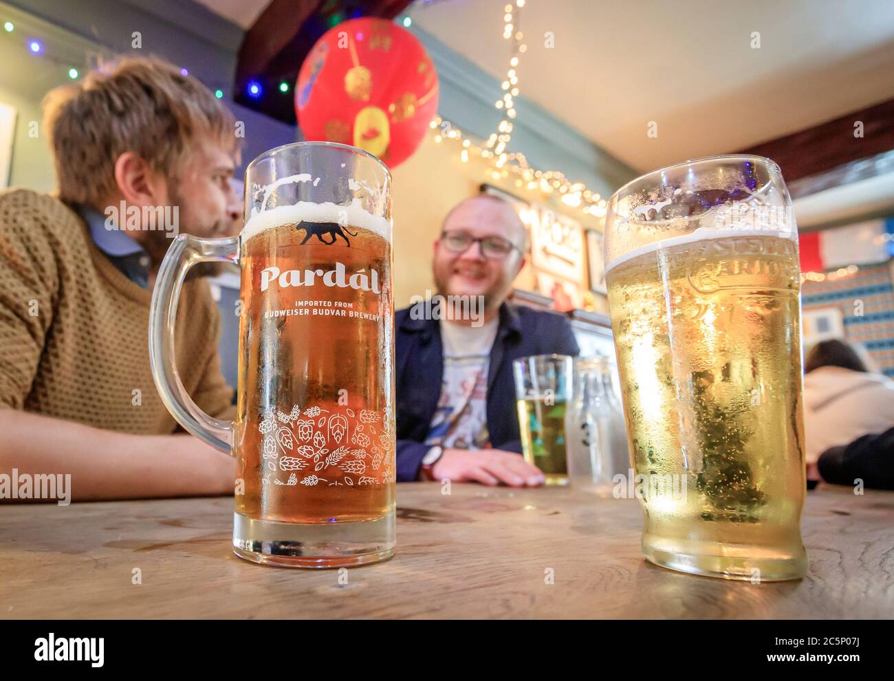 Customers enjoy a drink at the Golden Lion pub in Todmorden, West Yorkshire, as it reopens following the easing of coronavirus lockdown restrictions across England. Stock Photo