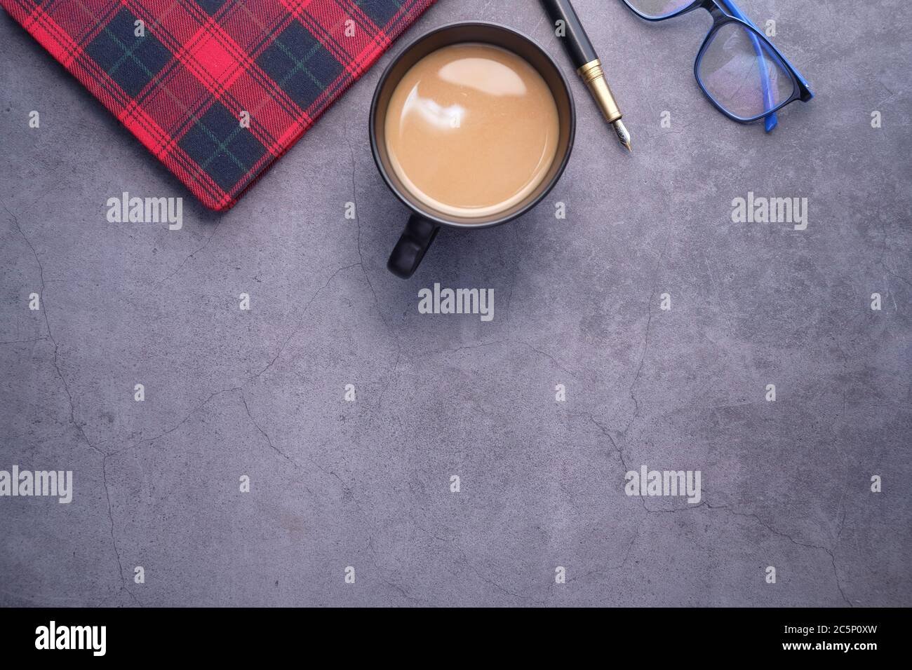 flat composition coffee, notepad and eyeglass on black background . Stock Photo