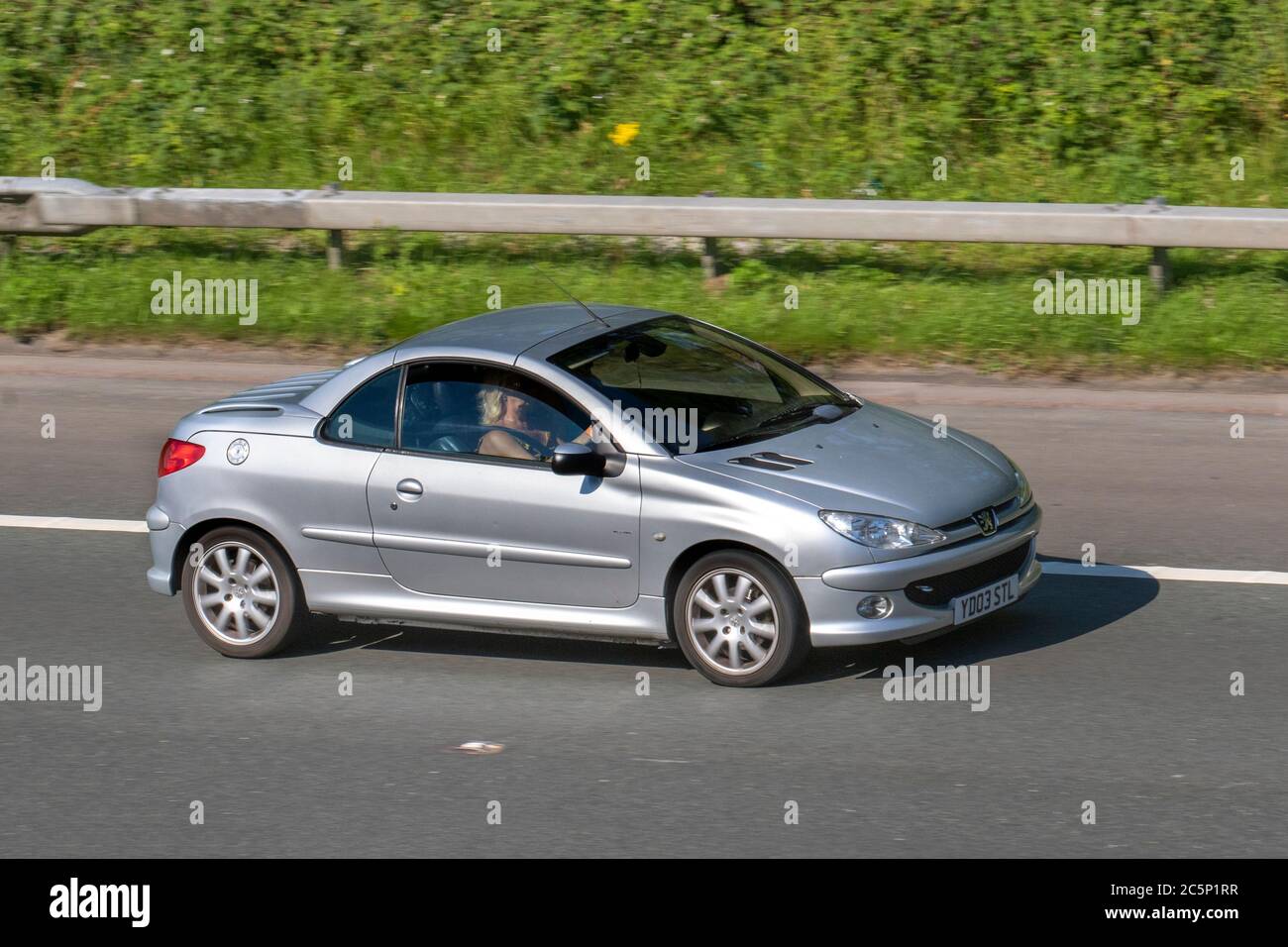 2003 silver Peugeot 206 CC; Vehicular traffic moving vehicles, cars driving vehicle on UK roads, motors, motoring on the M6 motorway highway network. Stock Photo
