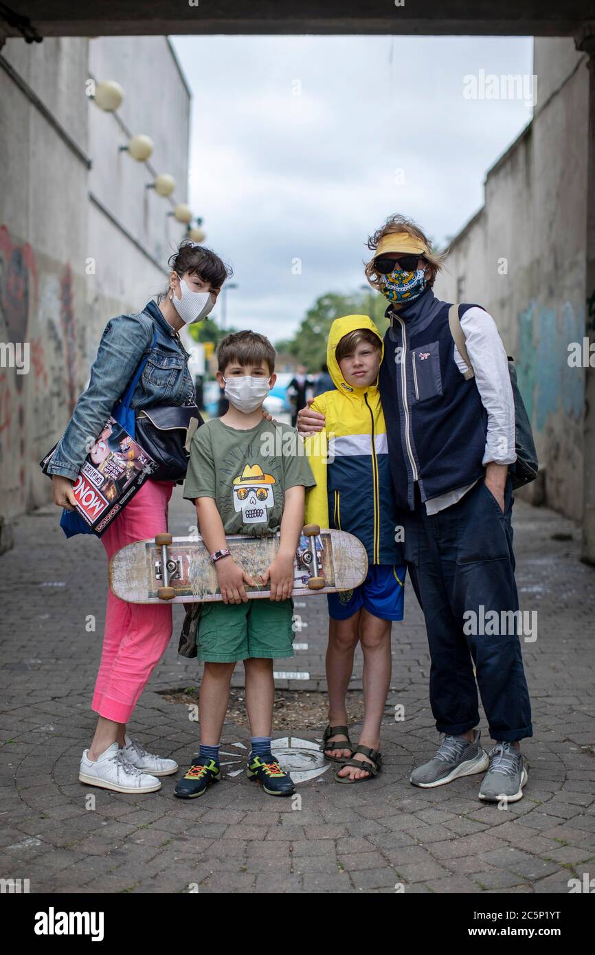 Peckham, England. 04th July 2020. Family friends wearing face coverings in Peckham, South London. Following the British Governments announcement to ease the lockdown rules, pubs, bars and restaurants reopen today having been closed for over three months in the UK due to the coronavirus pandemic. (photo by Sam Mellish / Alamy Live News) Stock Photo