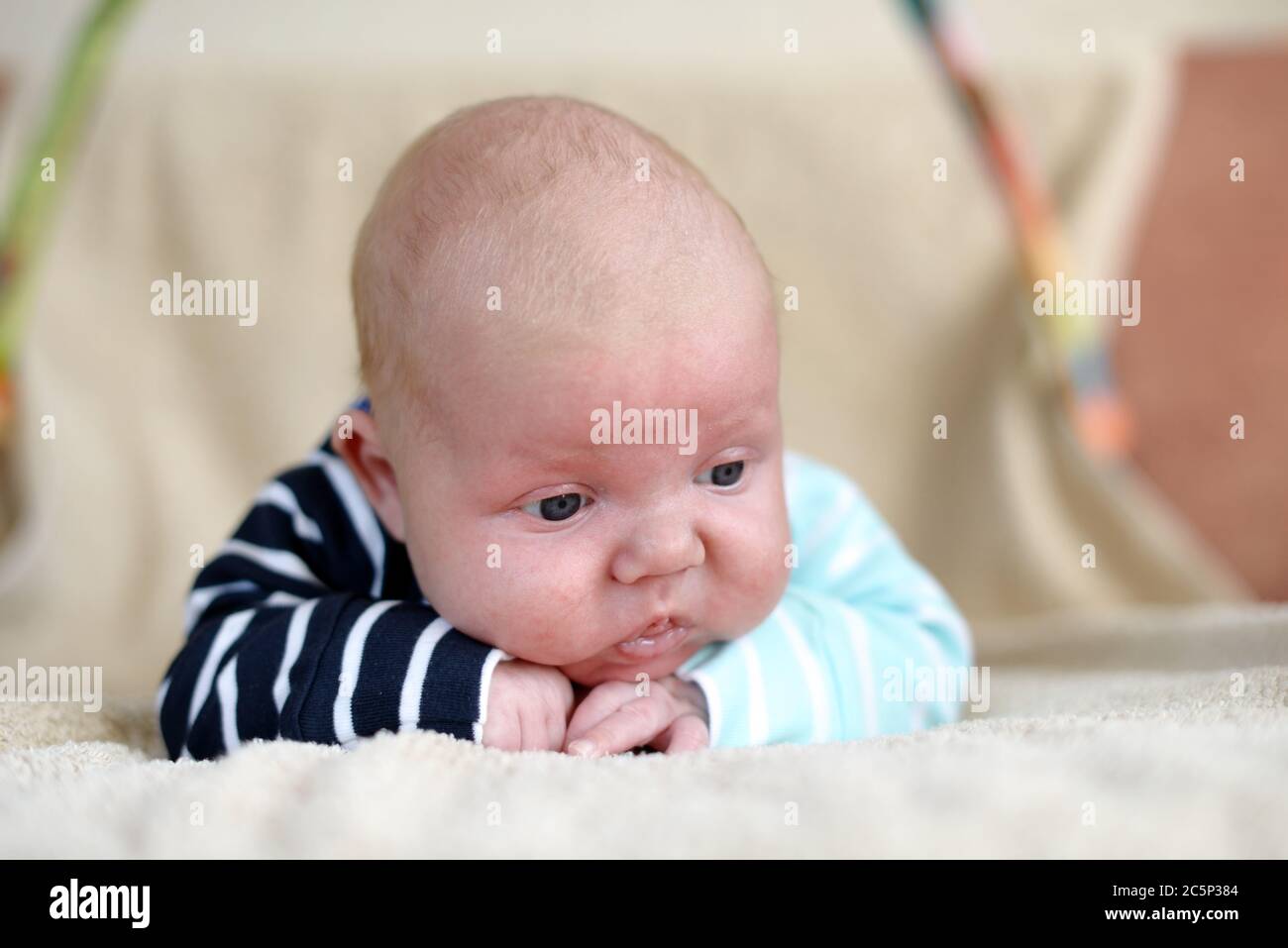 Cute 1,5 month old Caucasian baby boy with short blonde hair wearing a