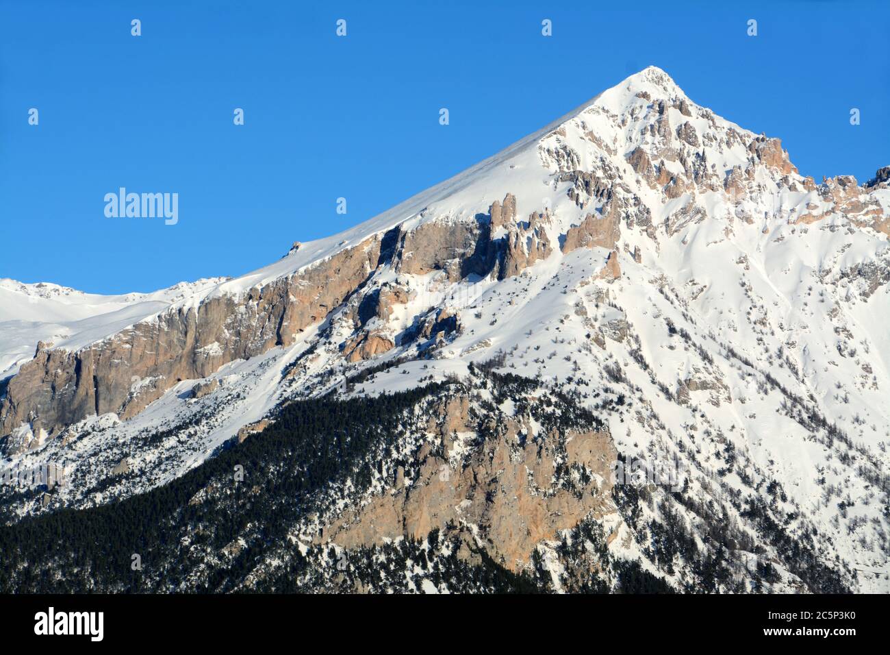 Mount Seguret is high m. 2,926. It is a mountain of Dolomite rock in the Cottian Alps. It has a characteristic pyramidal shape and dominates the city Stock Photo